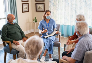 Assisted Living Facility Group of Seniors with Nurse Wearing a Mask