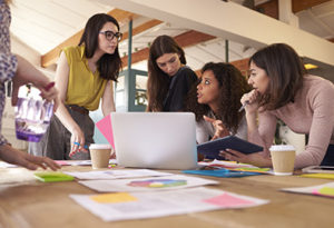 Women Working at a Desk in Discussion